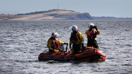 An RNLI boat searches the area in East Wemyss Fife after a fishing boat overturned in the Firth of Forth