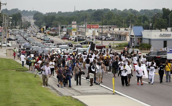 West Florissant Avenue during a parade in honor of Michael Brown Saturday Aug. 8 2015 in Jennings Mo. Sunday will mark one year since Michael Brown was shot and killed by Ferguson police officer Darren Wilson. (AP