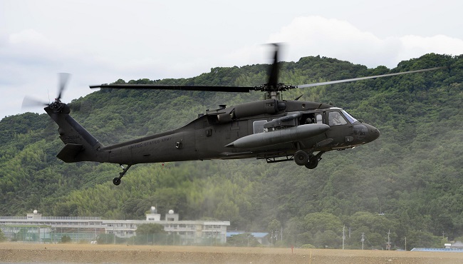 U.S. Army helicopter UH-60 flies during a Japan-U.S. joint disaster prevention drill in Kochi western Japan. A U.S. Army helicopter of the same type crashed off the southern Japanese island of Okinawa on Wednesday Aug. 12