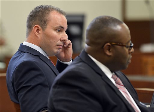 Police officer Randall Kerrick left and defense attorney Michael Greene listen during opening arguments at the Mecklenburg County Courthouse in Charlotte. N.C. Monday Aug. 3 2015. Kerrick is facing voluntary manslaughter charges in the shooting death