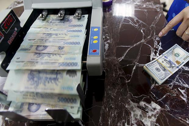 Vietnam devalues currency by 1 percent after China's move