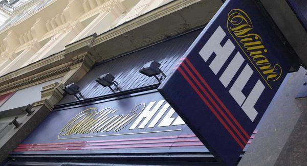 William Hill profit down; buys 29.4% of online lottery software firm NeoGames