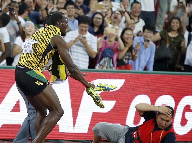 Winner Usain Bolt of Jamaica gets up after colliding with a cameraman on a Segway after competing in the 200 metres final during the 15th IAAF World Championships at the National Stadium in Beijing China. – Reuters pic