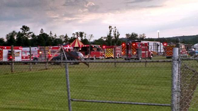 Fire & rescue trucks lined up at the fairgrounds in Lancaster N.H. after a circus tent collapsed killing two people and injuring more than a dozen