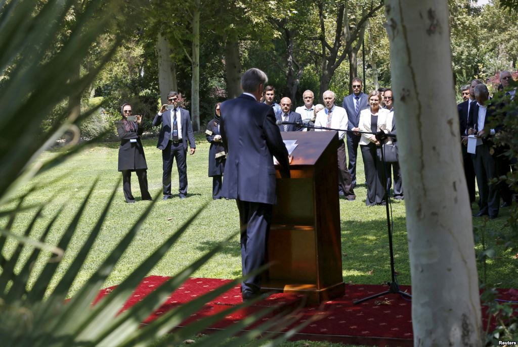 Embassy workers listen to Britain's Foreign Secretary Philip Hammond during the reopening of the British Embassy in Tehran Iran