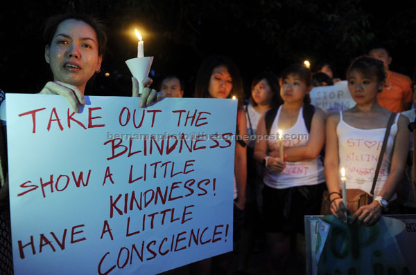 A participant in tears during a protest against the killing of stray dogs at Padang Kota Lama in Georgetown. — Bernama