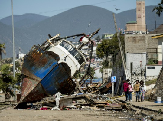 AFP  Martin BernettiA fishing boat that ran aground while moored in the port of Coquimbo some 445 km north of Santiago