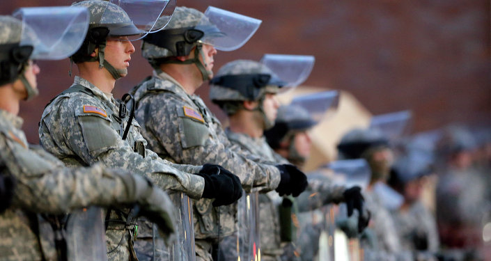 National Guard troops stand in front of the Ferguson Mo. Police Department a day after a grand jury's decision in the fatal shooting of Michael Brown. Newly released documents reveal that police planning for a grand jury announcement wanted Guard troops