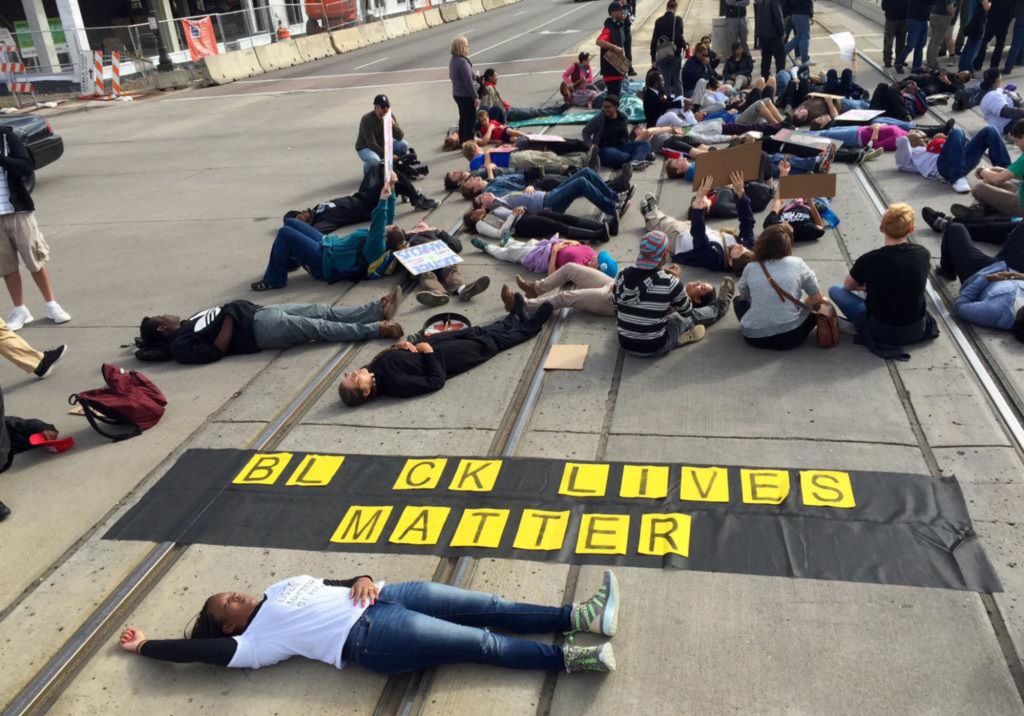 Protesters stage a die-in on the light rail tracks on Sunday morning. Meanwhile Metro Transit says buses are replacing Green Line traffic in the area