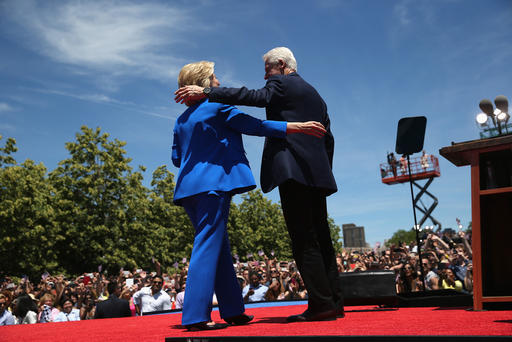 Democratic Presidential candidate Hillary Clinton and former President Bill Clinton embrace after Hillary officially launched her presidential campaign at a rally
