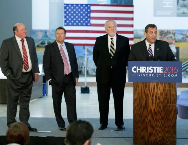 Republican presidential candidate New Jersey Gov. Chris Christie speaks during a news conference Tuesday Sept. 29 2015 in Des Moines Iowa. Looking on are supporters from left Jim Kersten Mikel Derby and Denny Elwel