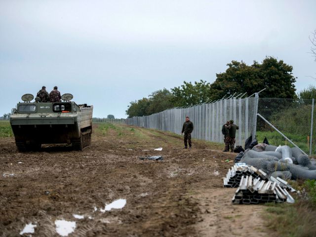 Hungarian soldiers setting a temporary fence in Beremend on the border with Croatia