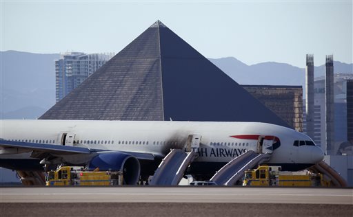 Casinos along the Las Vegas Strip can be seen behind a plane that caught fire at Mc Carren International Airport Tuesday Sept. 8 2015 in Las Vegas. An engine on the British Airways plane caught fire before takeoff