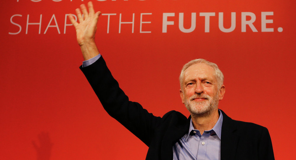 Jeremy Corbyn waves on stage after new is announced as the new leader of The Labour Party during the Labour Party Leadership Conference in London