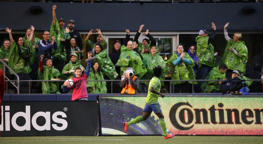 Seattle Sounders forward Obafemi Martins runs past cheering fans after he scored a goal against Toronto FC during the first half of an MLS soccer match Saturday Sept. 5 2015 in Seattle