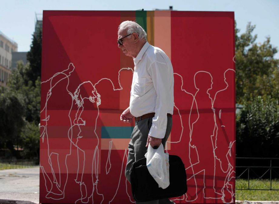 Former Greece's prime minister and leftist Syriza party leader Alexis Tsipras and New Democracy party leader Vangelis Meimarakis stand at their podiums before a televised debate in Athens