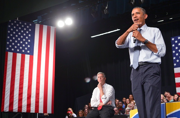 President Barack Obama speaks next to Education Secretary Arne Duncan during a town hall meeting on college accessibility