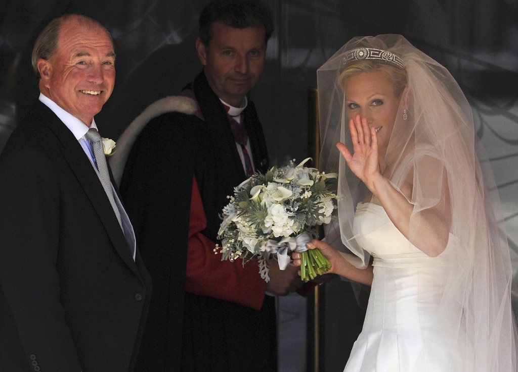 Britain's Zara Phillips the eldest granddaughter of Queen Elizabeth II arrives with her father Mark Phillips for her wedding to England rugby player Mike Tindall at Canongate Kirk in Edinburgh Scotland