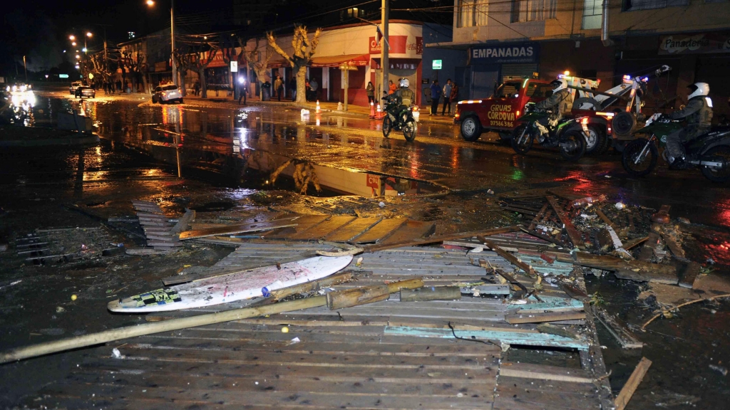 Police patrol a debris-strewn street in Valparaiso Chile following an 8.3 magnitude quake off the coast