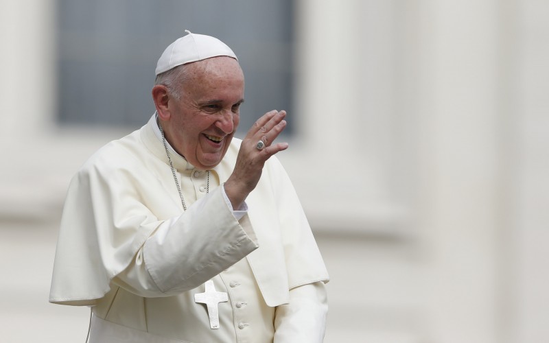 Pope Francis waves as he leaves his general audience in St Peter's Square at the Vatican yesterday S