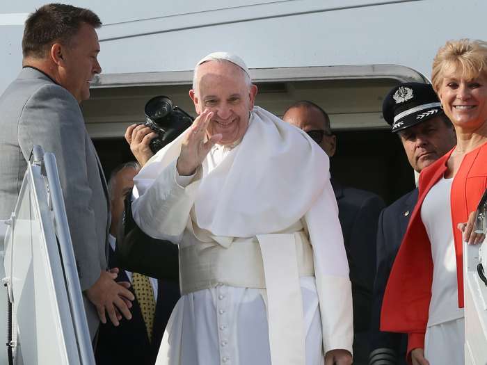 Pope Francis waves to the hundreds of faithful who came to see him off as he prepares to depart John F. Kennedy International Airport on Saturday. Associated Press