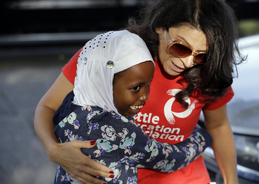 First grade student Halima Said 6 meets her new teacher Amber Simonton for the first time on the picket line where Simonton joined other teachers Wednesday morning Sept. 9 2015