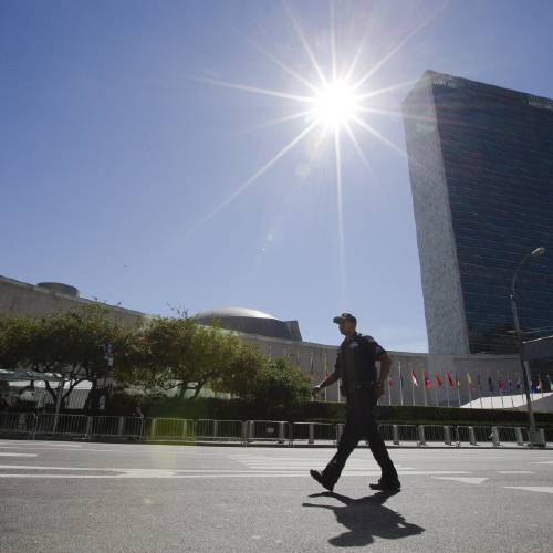 York City police officer walks past the United Nations on First Avenue during the UN General Assembly Thursday Sept. 24 2015 in New York