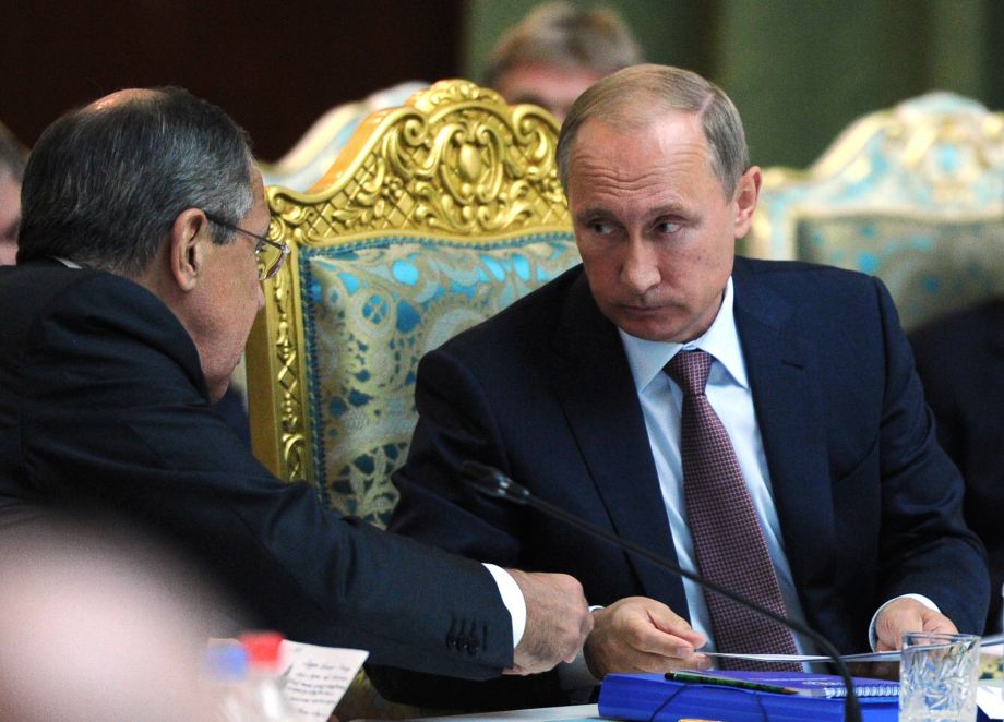 Russian President Vladimir Putin listens to Russia's Foreign Minister Sergey Lavrov left at the meeting of the Collective Security Treaty Organization in Dushanbe Tajikistan Tuesday Sept. 15 2015. Russian President Vladimir Putin on Tuesday