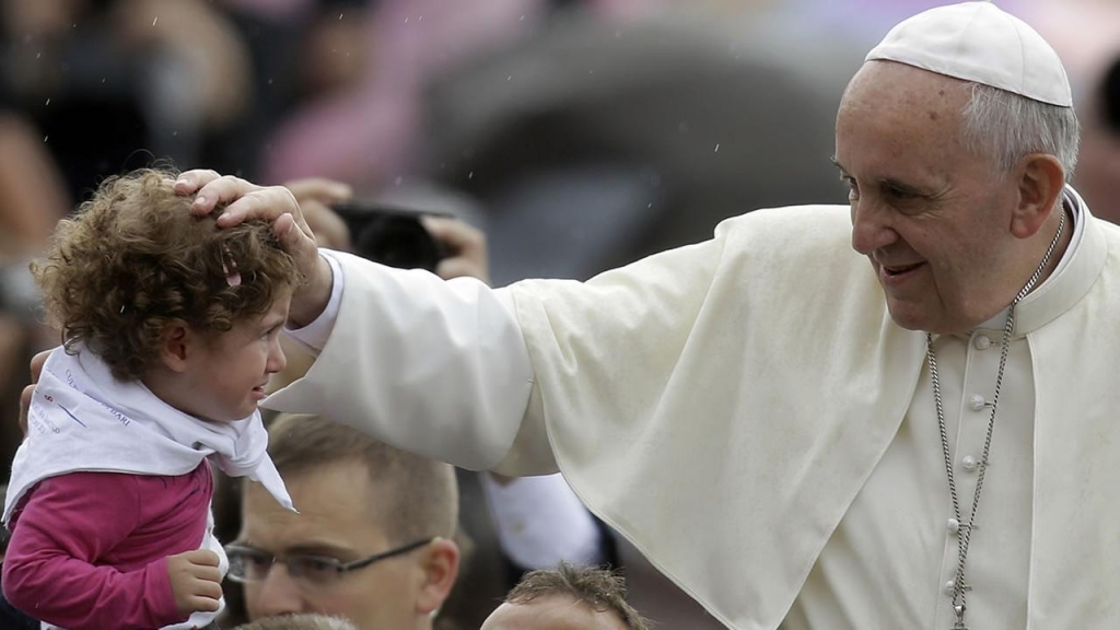 Pope Francis blesses a child during the weekly general audience in St. Peters Square at the Vatican Wednesday Oct. 9 2013