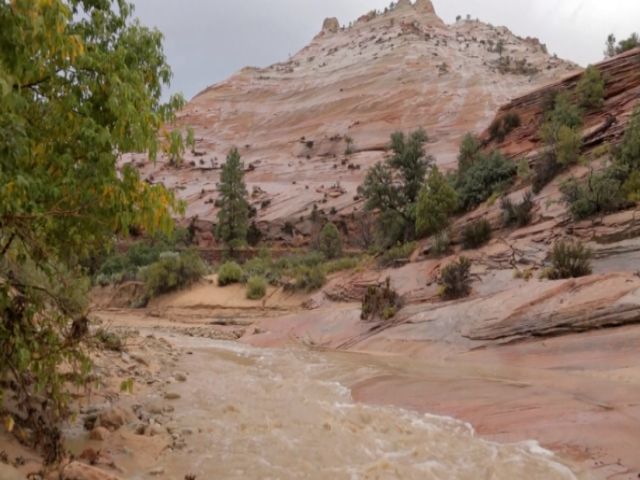 A woman and child examine a vehicle swept away during a flash flood Tuesday Sept. 15 2015 in Hilldale Utah. Authorities say several people have died in flash flooding that swept away vehicles on the Utah Arizona border. (Michael Chow  The Arizona Repu