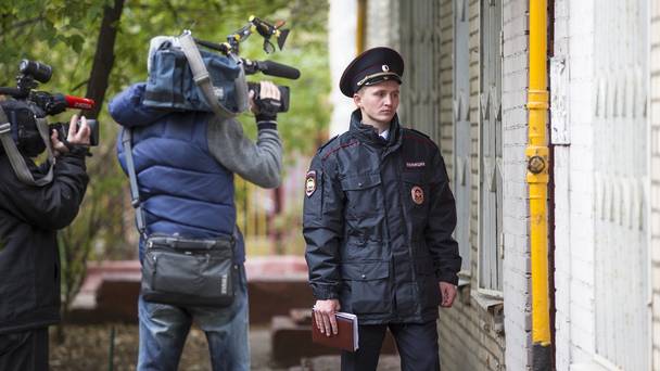 A Russian policeman stands at an entrance of the building where homemade explosives were found in Moscow