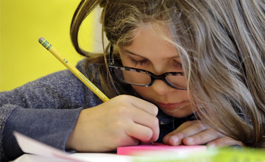 A fifth grader works on a project in her classroom at John Hay Elementary school in Seattle