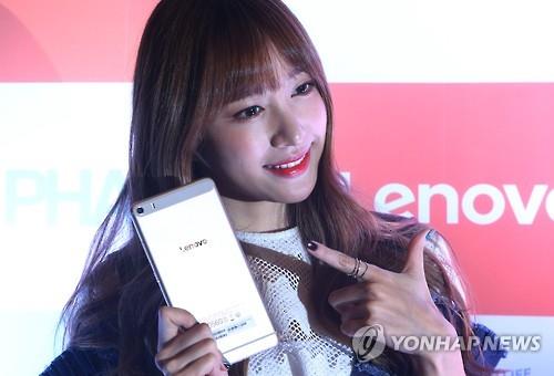 A model poses with Lenovo's 6.8-inch Phab Plus smartphone in this file