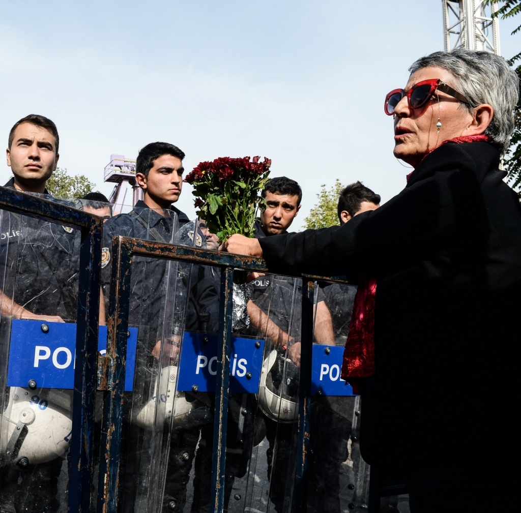 A protestor mourns at the blast site amid a heavy police presence