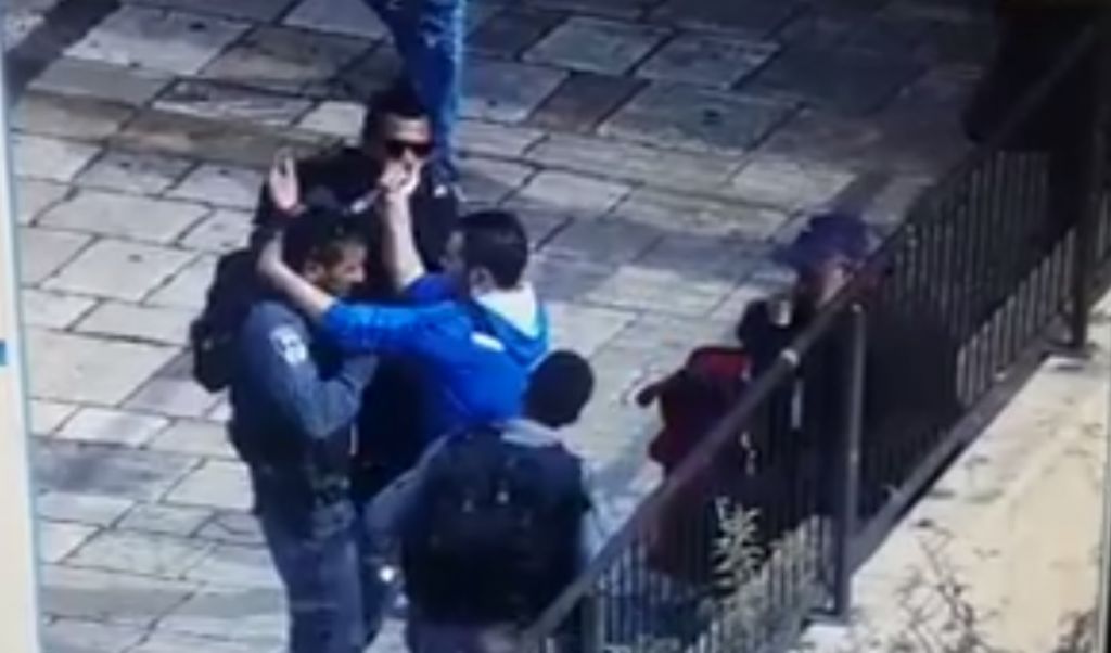 A screen capture from security footage showing a man trying to stab a police officer outside Jerusalem's Old City