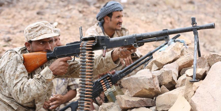 A soldier loyal to Yemen’s government aims a machine gun at a Houthi position in the country’s central province of Marib Monday