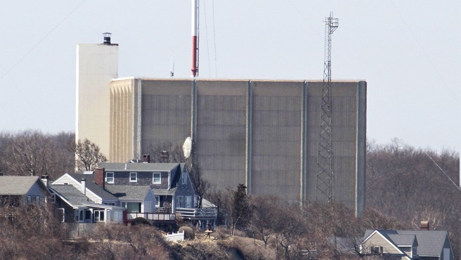 A tower at Pilgrim Nuclear Power Station in Plymouth Mass. is seen near the coast of Cape Cod Bay Wednesday