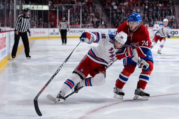 Alexei Emelin #74 of the Montreal Canadiens defends against Mats Zuccarello #36 of the New York Rangers