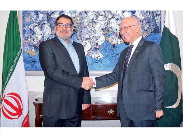 Ali Shamkhani and Sartaj Aziz shake hands prior to their meeting at the Foreign Office