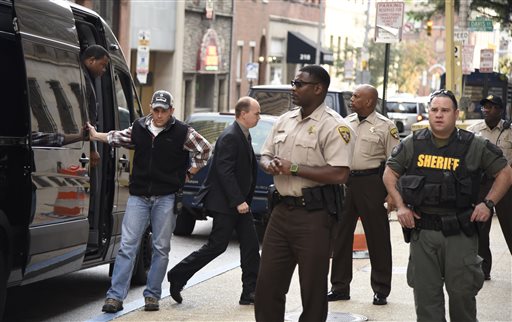 Baltimore city police officers charged in connection with Freddie Gray's death including officer Lt. Brian W. Rice third from left arrive at a side door for a court appearance on Tuesday Oct. 13 2015 in Baltimore. All six officers appeared