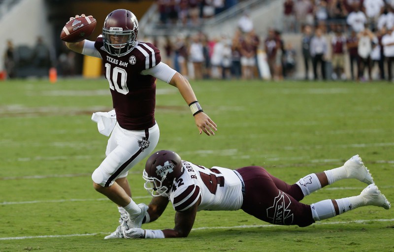 Texas A&M quarterback Kyle Allen avoids the tackle attempt by Mississippi State linebacker Beniquez Brown in the first half Saturday