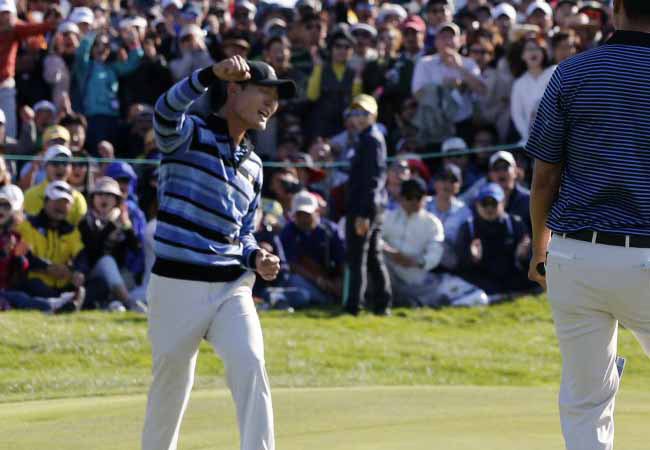 United States J.B. Holmes left and partner Bubba Watson celebrate after winning a hole during their four ball match at the Presidents Cup golf tournament at the Jack Nicklaus Golf Club Korea in Incheon South Korea Friday Oct. 9 2015.(AP