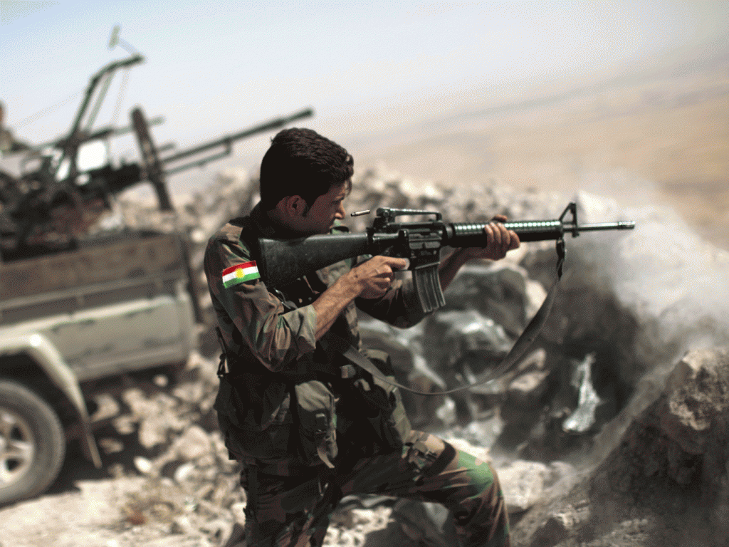 An Iraqi Kurdish peshmerga fighter fires on an Isis position JM LOPEZ  AFP  Getty Images