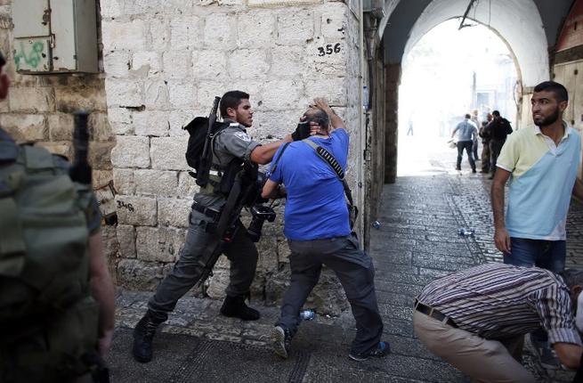 Six Israelis injured in stabbings; Palestinian killed