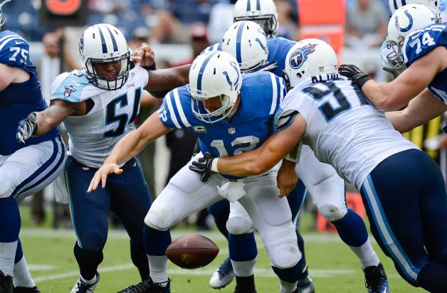 Indianapolis Colts quarterback Andrew Luck fumbles the ball as he is hit by Tennessee Titans defensive end Karl Klug in the second half of an NFL football game Sunday Sept. 27 2015 in Nashville Tenn. Luck recovered the ball