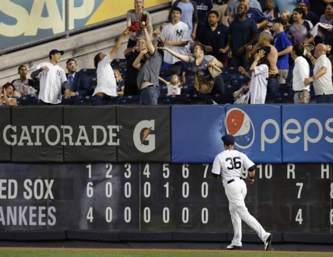 Yankees right fielder Carlos Beltran watches as a spectator catches Blake Swihart's eighth-inning two-run home run