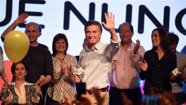 Argentine presidential candidate Mauricio Macri waves at supporters at the party's headquarters in the capital Buenos Aires