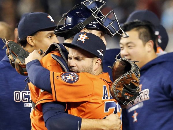 Houston Astros catcher Jason Castro center left embraces Astros second baseman Jose Altuve after the Astros beat the New York Yankees 3-0 in the American League wild card baseball game at Yankee Stadium in New York Tuesday Oct. 6 2015. Astros center