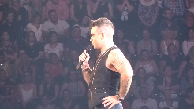 Awkward Robbie Williams told a'sexy secretary joke to a fan in the audience- only to be left red-faced to discover she was only 15 years old