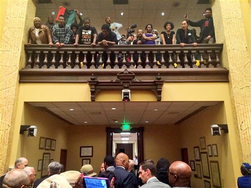 Protesters shout as council members leave the chamber at city hall in Baltimore Wednesday Oct. 14 2015. A city council subcommittee voted to make Kevin Davis the permanent police commissioner Wednesday.  WASHIN